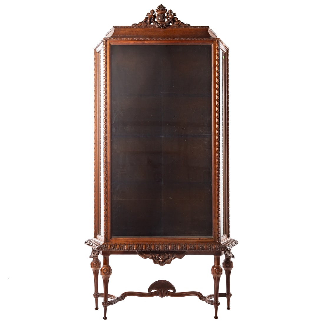 Louis XVI Style Mahogany Curio Cabinet: Carved mahogany glass fronted case with projecting base resting on turned and fluted legs, 78 1/2 in. H, 43 in. W, 18 in. D From the Estates of James Thomas and Mary Seale Scrivener