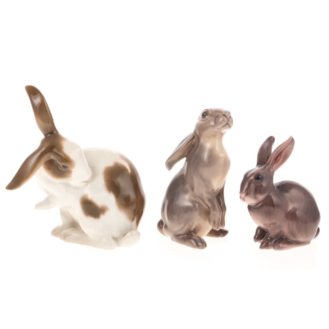 Two Dahl-Jensen and One Bing & Grondahl Hare: Dahl Jensen including Hare Standing, #1140, 4 in. H, Hare, #1141, 3 in. H; and Bing & Grondahl Rabbit, #1833, sculpted by Dahl Jensen, 4 1/2 in. H. For further reading see "Dahl-Jensen Porcelain Figur