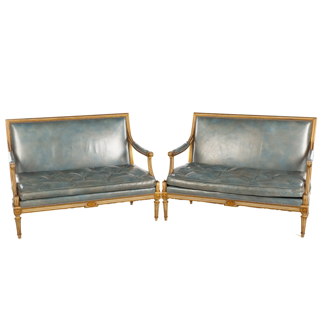 A Pair of Louis XVI Style Vinyl Settees: 20th century, carved and partial giltwood frames with partial upholstered arms ending in scroll returns extending onto turned and reeded legs, button upholstered seats, each: 33 1/2 in. H, 48 in. W, 2