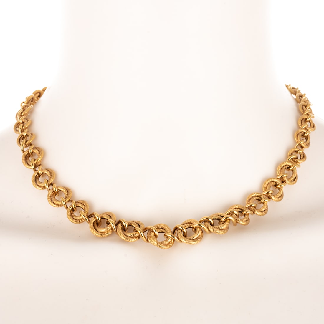 A Tapered Textured Link Necklace in 14K: 14K yellow gold tapered link necklace made in Italy designed with double open circle textured links alternating between high polish twist link, large spring ring clasp, largest link measures 1/2 in. W