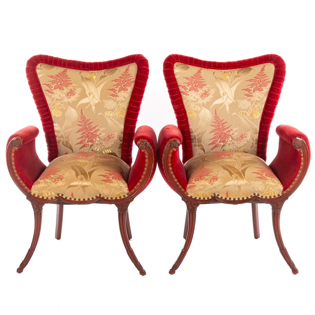 A Pair of Art Moderne Upholstered Armchairs: 20th century, flared upholstered backs, scroll-form carved mahogany arms, ending in cornucopia carved sabre legs, 40 1/2 in. H, 25 1/2 in. W, 22 1/2 in. D