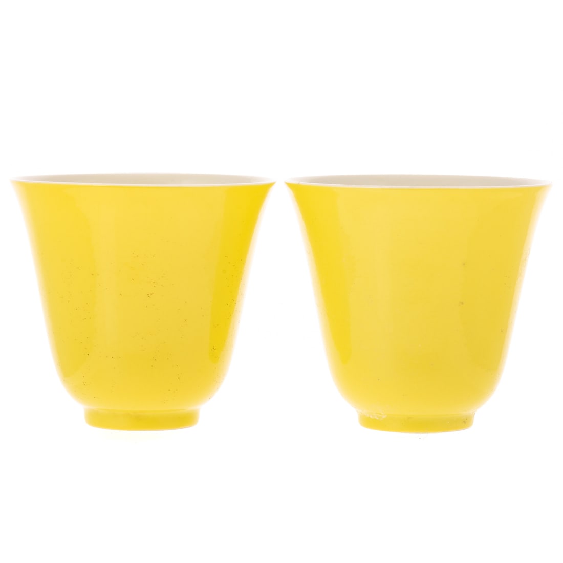 A Pair of Chinese Lemon Yellow Enamel Cups: 18th century, a pair of Chinese yellow lemon enamel cups with six character mark in blue underglaze, deep bell form, 3 1/8 in. H, 3 3/8 in. Diam.