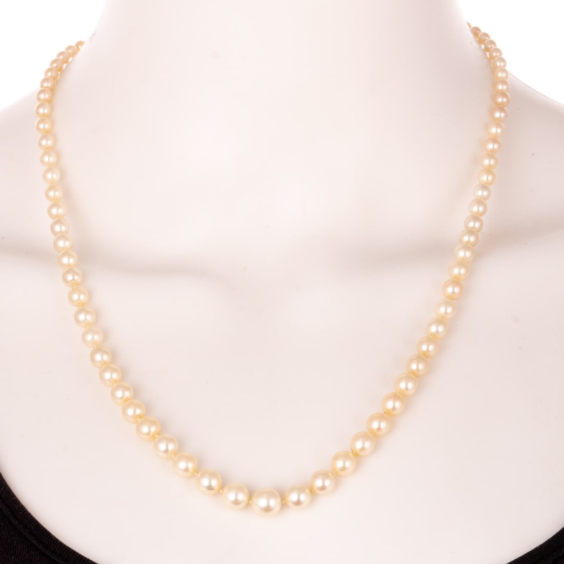 A Strand of Graduated Cultured Pearls: Strand of graduated cultured pearls, sizes range from 8.2 mm at the center to 3.5 mm in the back, sterling fishhook clasp, strung with knots in between pearls, 21 in. L, 20.6 grams Provenance: From th