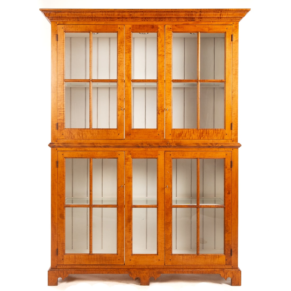 David T. Smith Tiger Maple Cupboard: Two part cupboard with extending cornice and four glazed doors supported by bracket feet, David T. Smith, Morrow, Ohio brand on verso, 84 in. H, 63 in. W, 18 in. D