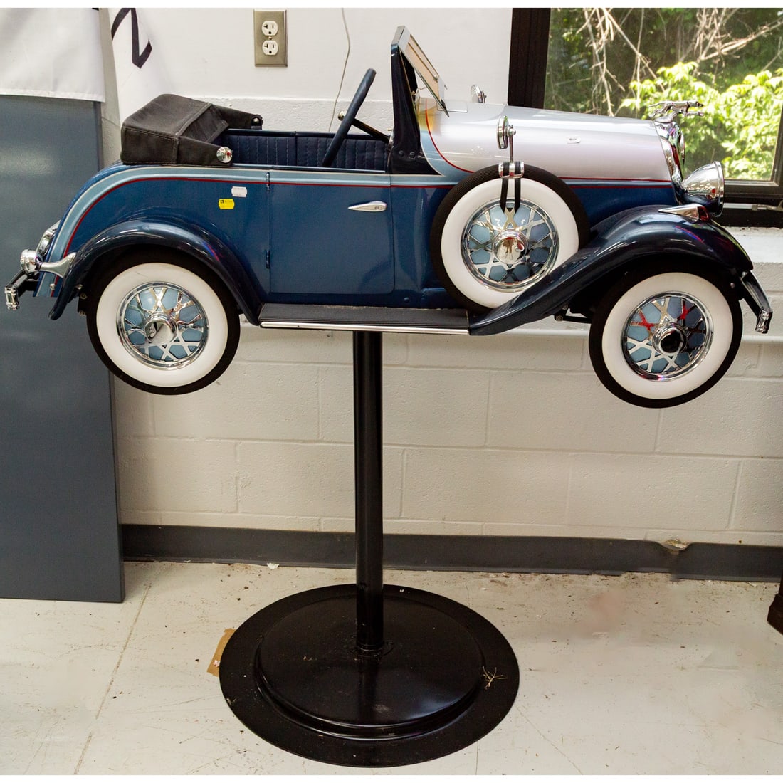 A Reproduction Lincoln Pedal Car: Modeled on a 1935 Zephyr, with a modern iron pedestal stand