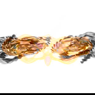 A Pink & Green Tourmaline Mermaid Bangle in 14K: 14K yellow gold Italian hinged bangle featuring a star of bezel set elongated pear cabochons of pink and green tourmaline with a faceted high polish gold center being held up by two mermaids with