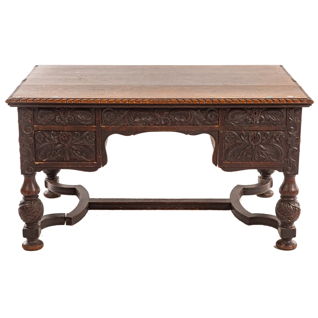 Renaissance Revival Carved Oak Partners Desk: In the Spanish Baroque manner, oak plank top with gadrooned edges over a ten-drawer case, heavy carved legs connected by a shaped stretcher, 29 1/4 in. H, 53 3/4 in. W, 36 1/2 in. D