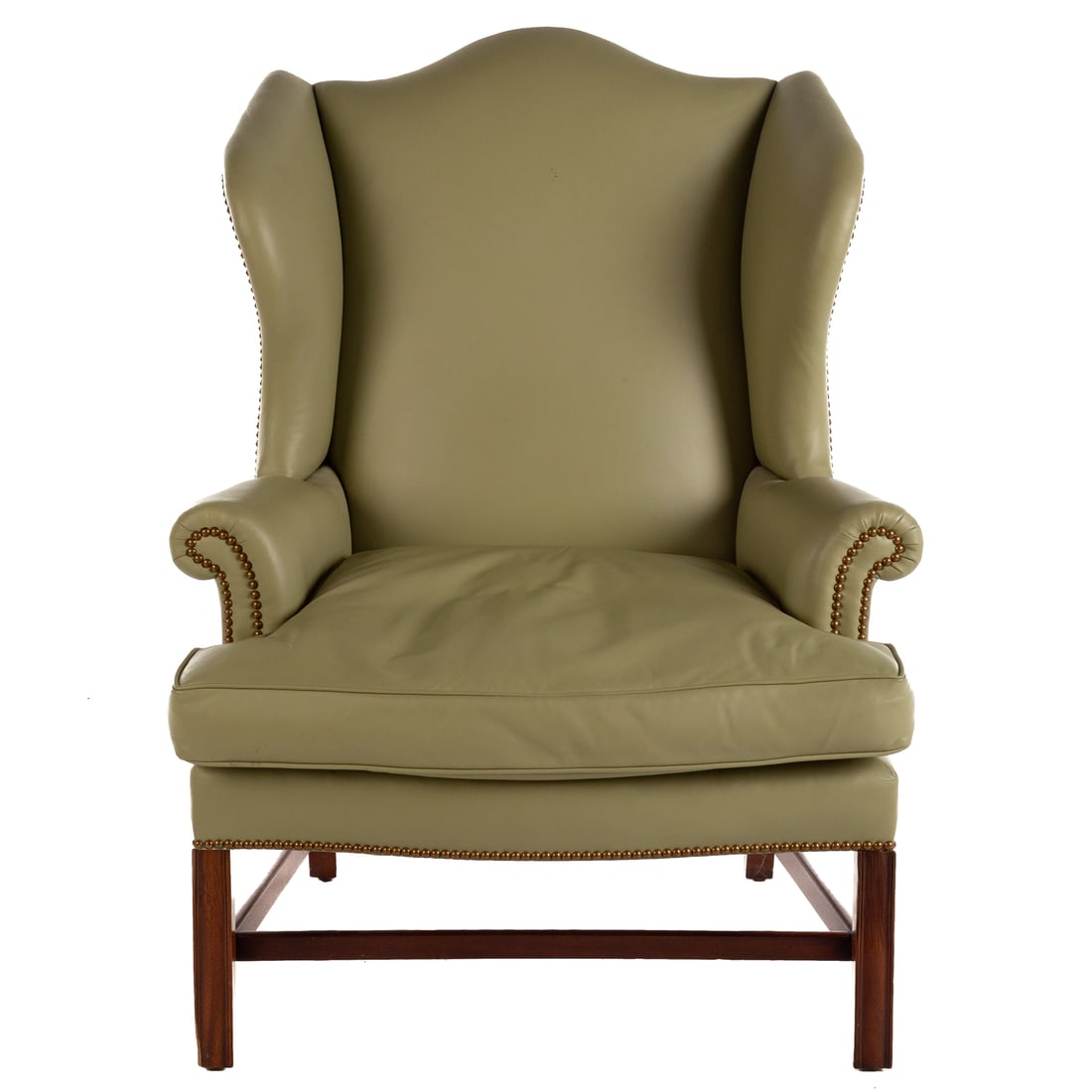 Kittinger Chippendale Style Mahogany Wing Chair: Fully leather upholstered with hobnail embellishments, carved straight legs connected by stretchers, 45 in. H, 31 1/2 in. W, 26 1/2 in. D