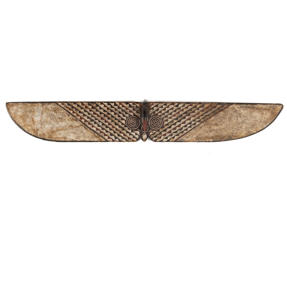 An African Plank Mask, Bwa Peoples: (Burkina Faso, Second half, 20th century) A hawk with serrate pattern and largely white wings, the back with curvilinear pattern. A single piece of carved wood with painted surface, 11 1/4 in. H, 78 1