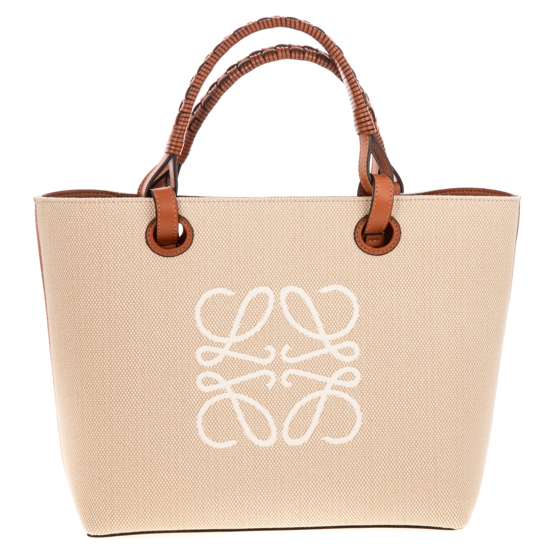A LOEWE Anagram Small Tote: A cream and tan LOEWE Anagram Small Tote with braided handles and dual shoulder straps, leather trim, and graphic print at front. Leather lining, dual interior flat wall pockets, and open top. Include