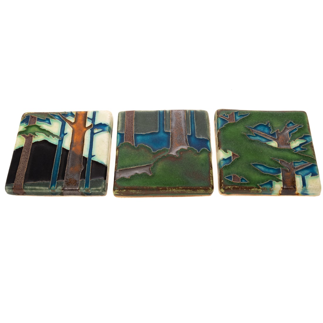 Arts & Crafts Motawi Pottery Tile Triptych: Three Motawi pottery tiles as depicting wooded outdoors of trees and mountain, all marked Motawi, all approx. 3 3/4 x 4 in.