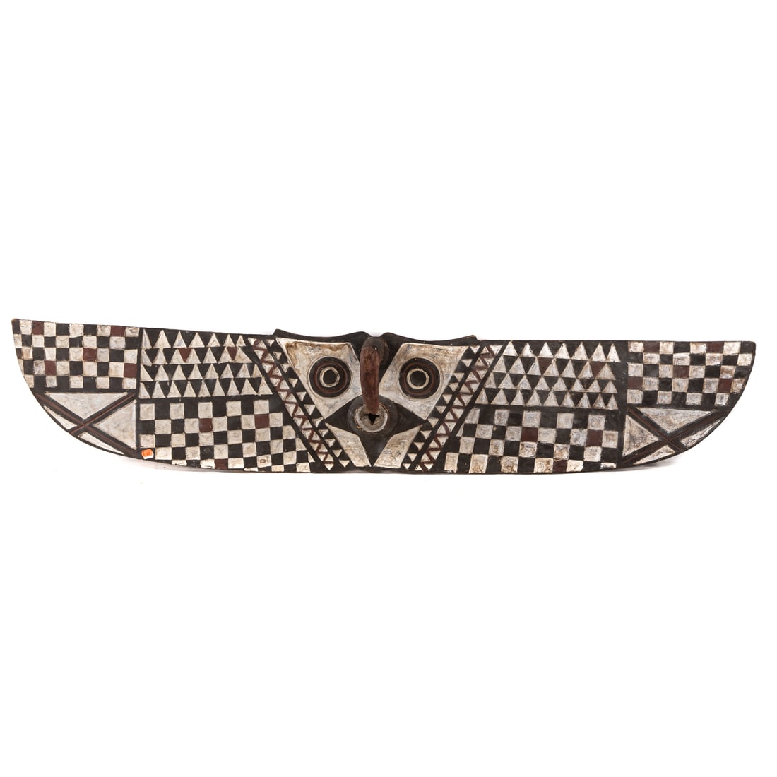 An African Plank Mask, Bwa Peoples: (Burkina Faso, second half, 20th century) A hawk with checkerboard and serrate pattern covering the front, the back with checkered pattern, carved wood with painted surface, 13 1/2 in. H, 69 in. W, ap
