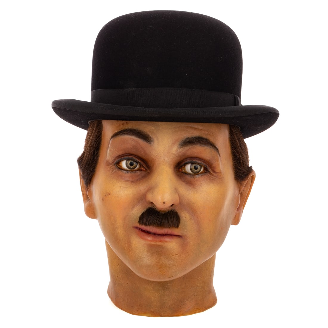 Charlie Chaplin, Composite Bust & Hat: An original custom and hand painted film bust, of Chaplin with hair, 11 in. H, 8 1/2 in. W, 9 1/2 in. D. Includes a replica of Charlie's iconic bowler hat, of the period, by "Adam" brand Provenance: F