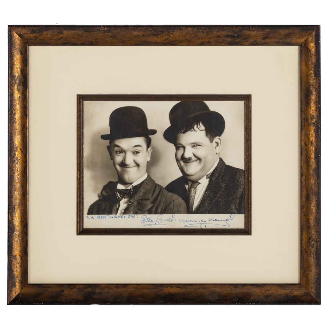 Stan Laurel & Oliver Hardy, Autographed Photo: Comprising an early 20th century photograph of Laurel and Hardy, signed and inscribed "Our best wishes to Joe!/Stan Laurel/Oliver Hardy," sight size: 7 1/2 x 9 1/2 in., framed size: 16 1/4 x 18 1/4 in
