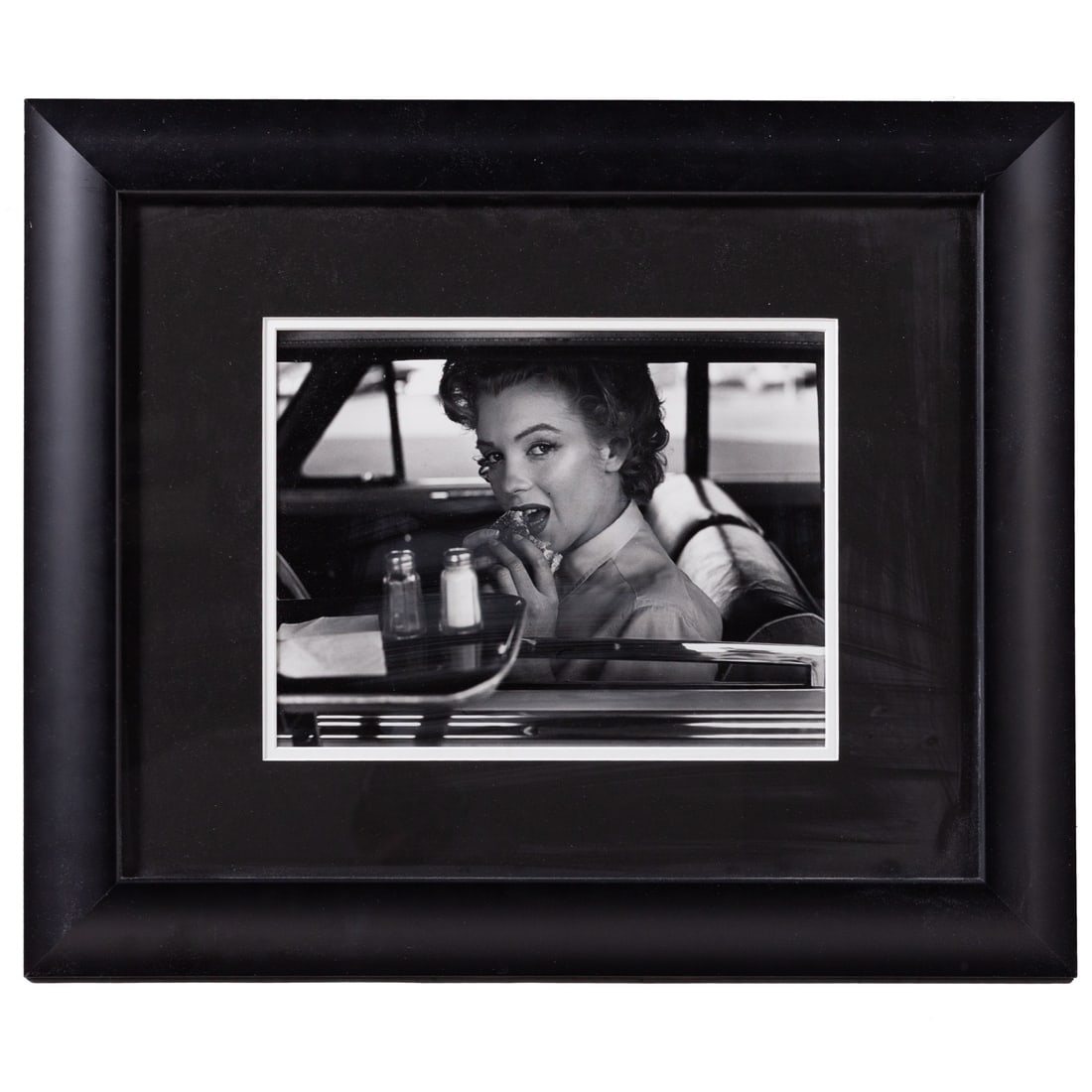 Philippe Halsman. "Marilyn Monroe at the Drive-in": A circa 1952 silver gelatin print of Marilyn Monroe eating a burger at the fast food drive-in, sight size: 9 1/4 x 12 1/4 in., framed size: 20 x 24 in. Provenance: From the Estate of a Private Collect