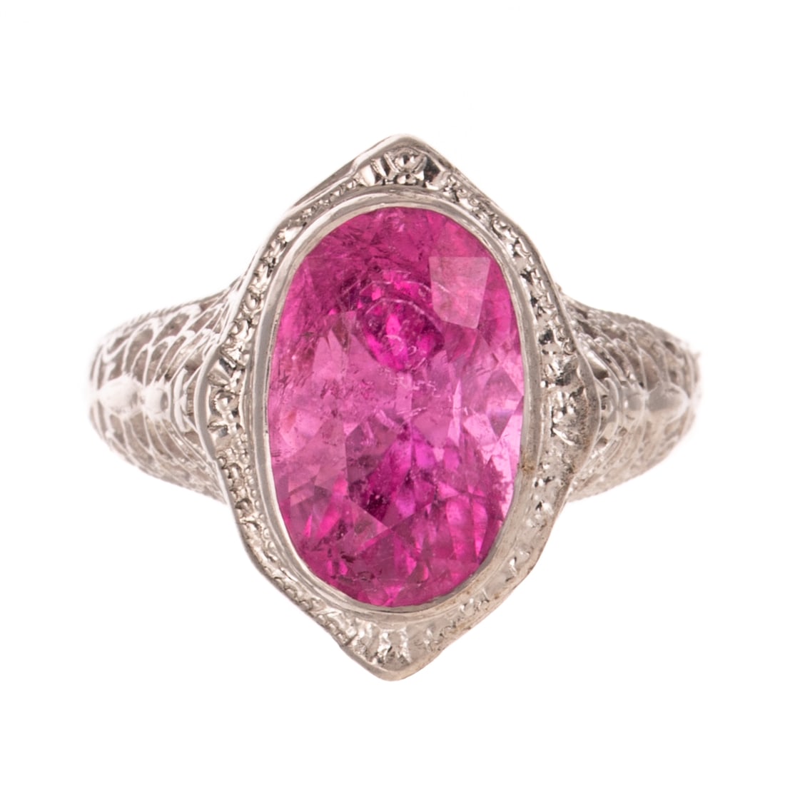 A Pink Tourmaline Filigree Ring in 14K: 14K white gold ring featuring an oval shaped pink tourmaline weighing approx. 3.80 carats bezel set in a butterfly filigree setting continuing onto shank, sz 5.5, 3.0 grams