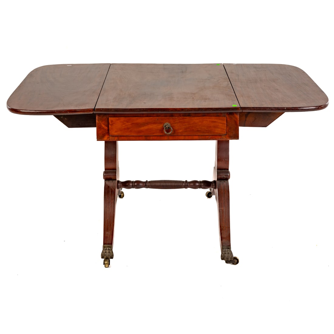 Federal Style Walnut Drop Leaf Table: In the Duncan Phyfe manner, double curved corner drop leafed top resting on a two drawer apron on a shaped and sabre legged trestle base ending in casters, 28 3/4 in. H, 42 in. W, 25 in. D