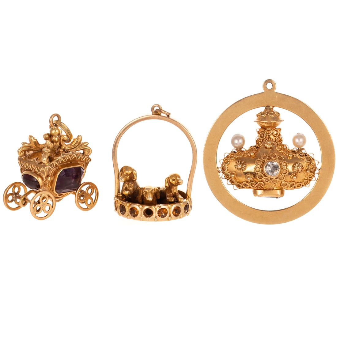 A Trio of Large Whimsical Charms in 18K & 14K: 1) 18K yellow gold carriage charm with two cabochon amethysts bezel set and two step cut amethysts bezel set, articulated wheels, 1 in. W, 2) 18K yellow gold charm featuring a perfume flacon style bot