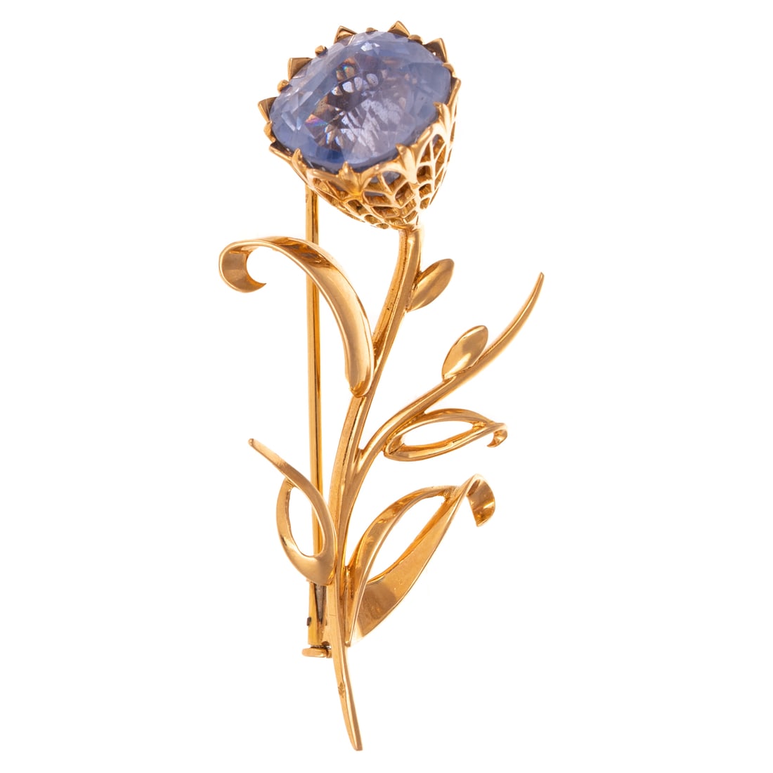A French 20 Ct Sapphire Flower Brooch in 18K: 18K yellow gold French flower brooch featuring a cushion cut cornflower blue sapphire, color and inclusions indicate Ceylon region, weighing approx. 20.00 carats measuring approx. 14.5 x 14.5 mm custo