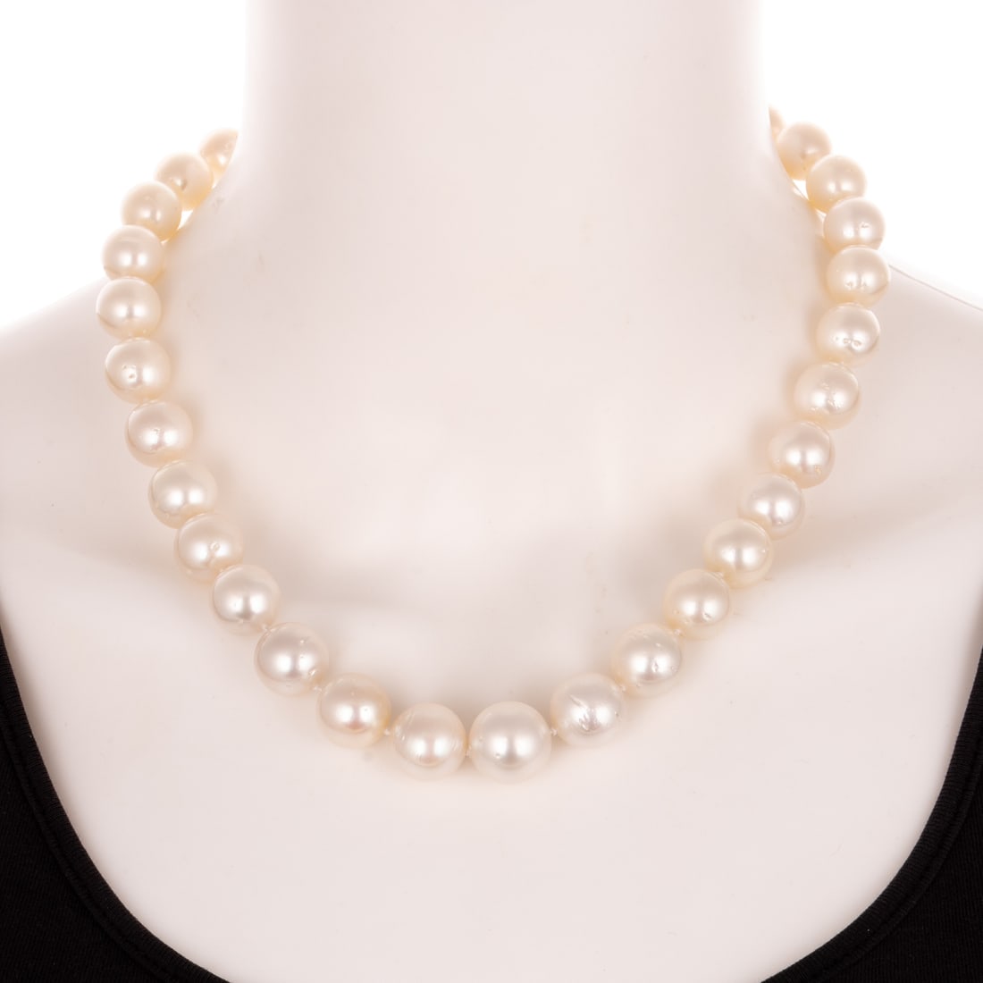 A Strand of Graduated South Sea Pearls in 14K: Strand of 33 South Sea white cultured pearls measuring 12 - 15.4 mm with white color light pink overtones, good luster, spotted, knotted, 14K white gold bead clasp, 18 1/4 in. L, 103.4 grams