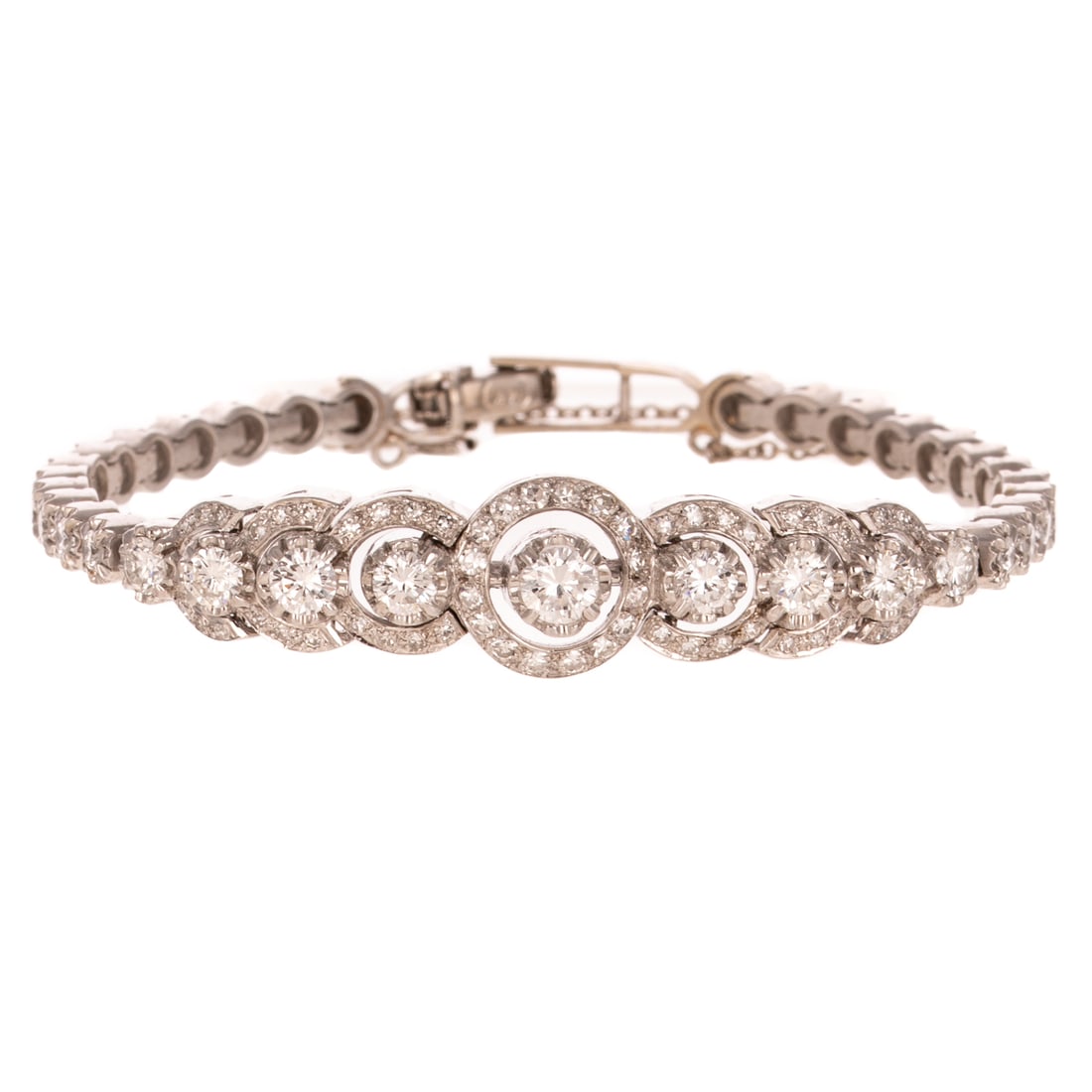 A Tapered Diamond Line Bracelet in 14K: c.1940s, 14K white gold slightly tapered bracelet featuring central round diamonds with concentric diamond halos, ending in classic prong set line bracelet at the back, approx. 2.50 ctw with an averag