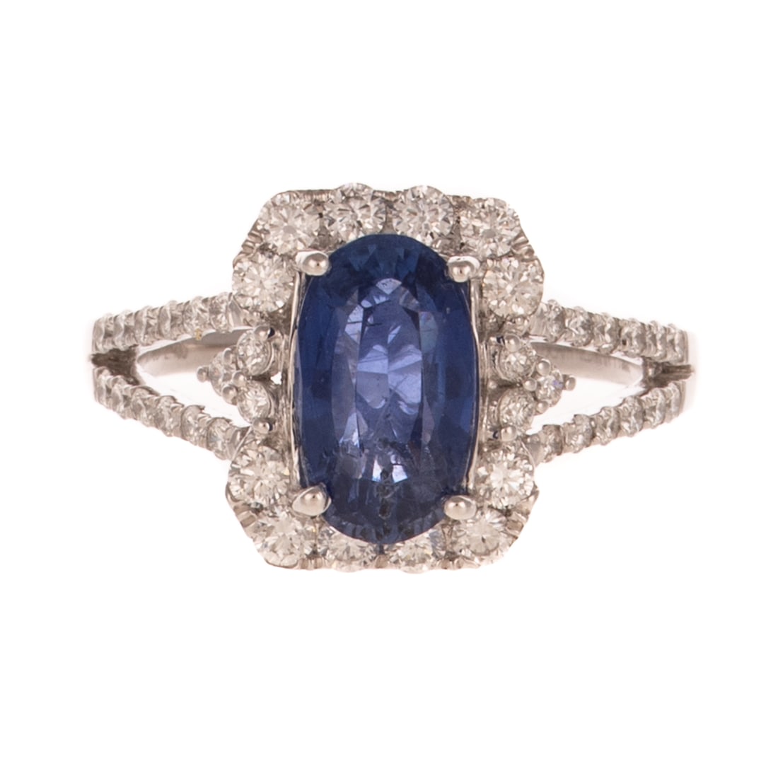 A GIA 2.43 ct Sapphire & Diamond Ring in Platinum: Platinum ring by Oscar Friedman featuring a prong set oval velvet blue sapphire weighing 2.43 carats, accompanied by a copy of GIA Report #5232569927, surrounded by a decorative halo of bead set round