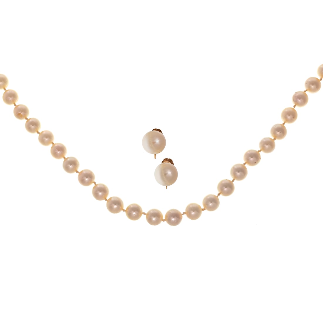 An Opera Length Strand of Pearls & Ear Clips in 14K: Strand of very fine cultured pearls with high lustre and slight rose undertone measuring 7.5 - 8mm, no clasp, 32 in. L along with 14K yellow gold ear clips featuring 10.5mm cultured pearls with screw