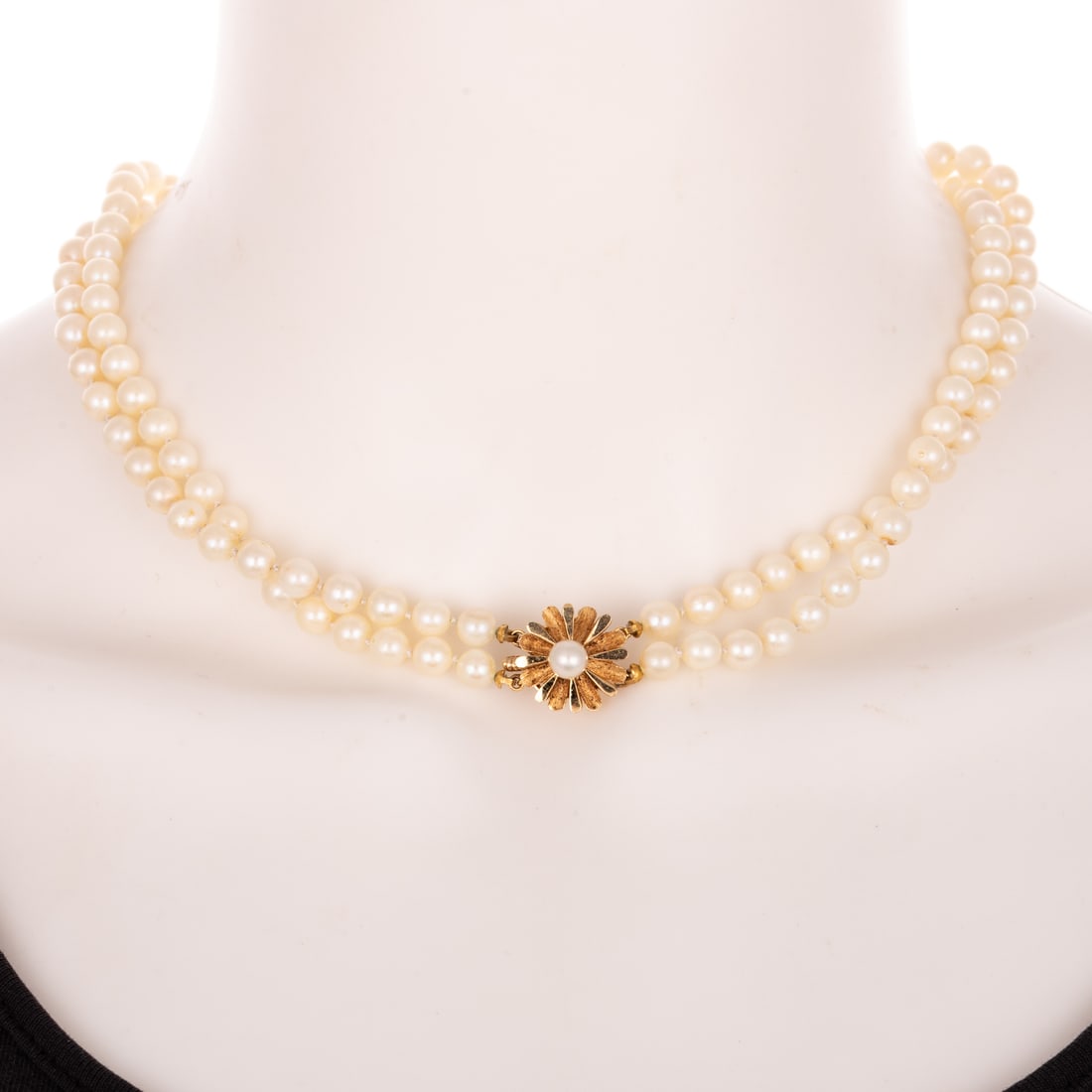 A Double Strand of Pearls with 14K Clasp: Double strand of cultured pearls measuring 5.5 - 6 mm with 14K yellow gold floral clasp with pearl in center, 17 in. L, 37.2 grams Provenance: From the Estate of Dr. Vira Froehlinger, Towson, MD