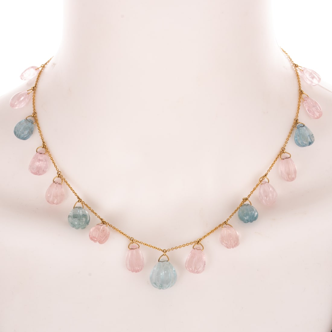 A Carved Morganite & Aquamarine Dangle Necklace in 18K: 18K yellow gold cable link chain with alternating carved morganite and aquamarine drops evenly spaced throughout half the necklace, spring ring clasp, adjustable lengths at 16 in., 17 in., and 18 in.