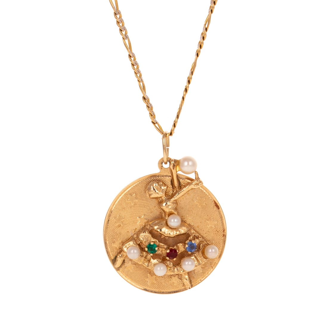 A Ballerina Pendant Necklace in 14K: 14K yellow gold round disc pendant featuring a ballerina in high relief wearing a bejeweled skirt of seed pearls and multi-colored accents, holding one pearl aloft, against a textured ground with