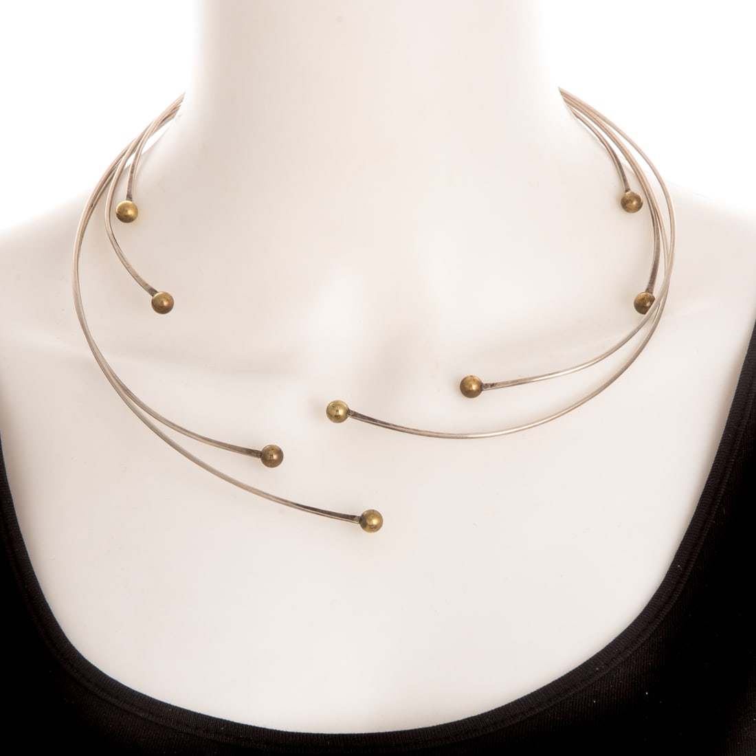 An Early Betty Cooke Four-Wire Necklace in Sterling Silver & Brass: Four sterling silver wire collars by Betty Cooke (1924 - 2024), Baltimore, MD high polish finish with each terminating in high polish brass spheres, each signed, 40.6 grams tw Provenance: From a life