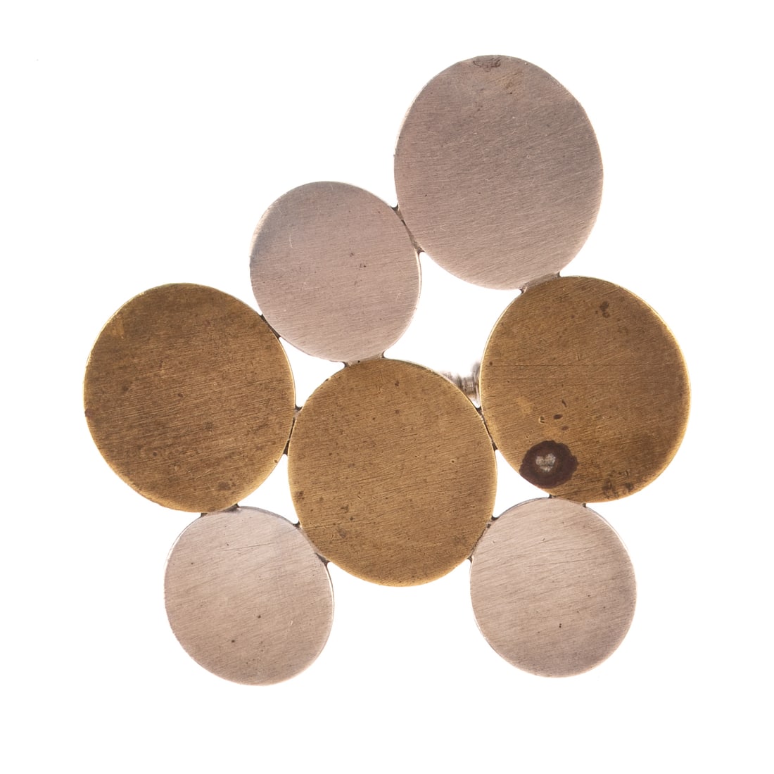 A Betty Cooke Pebble Brooch in Sterling & Brass: Sterling silver and brass round pebble brooch by Betty Cooke (1924 - 2024), Baltimore, MD featuring four high polish sterling silver discs alternating with three high polish brass discs, signed, 1 3/4
