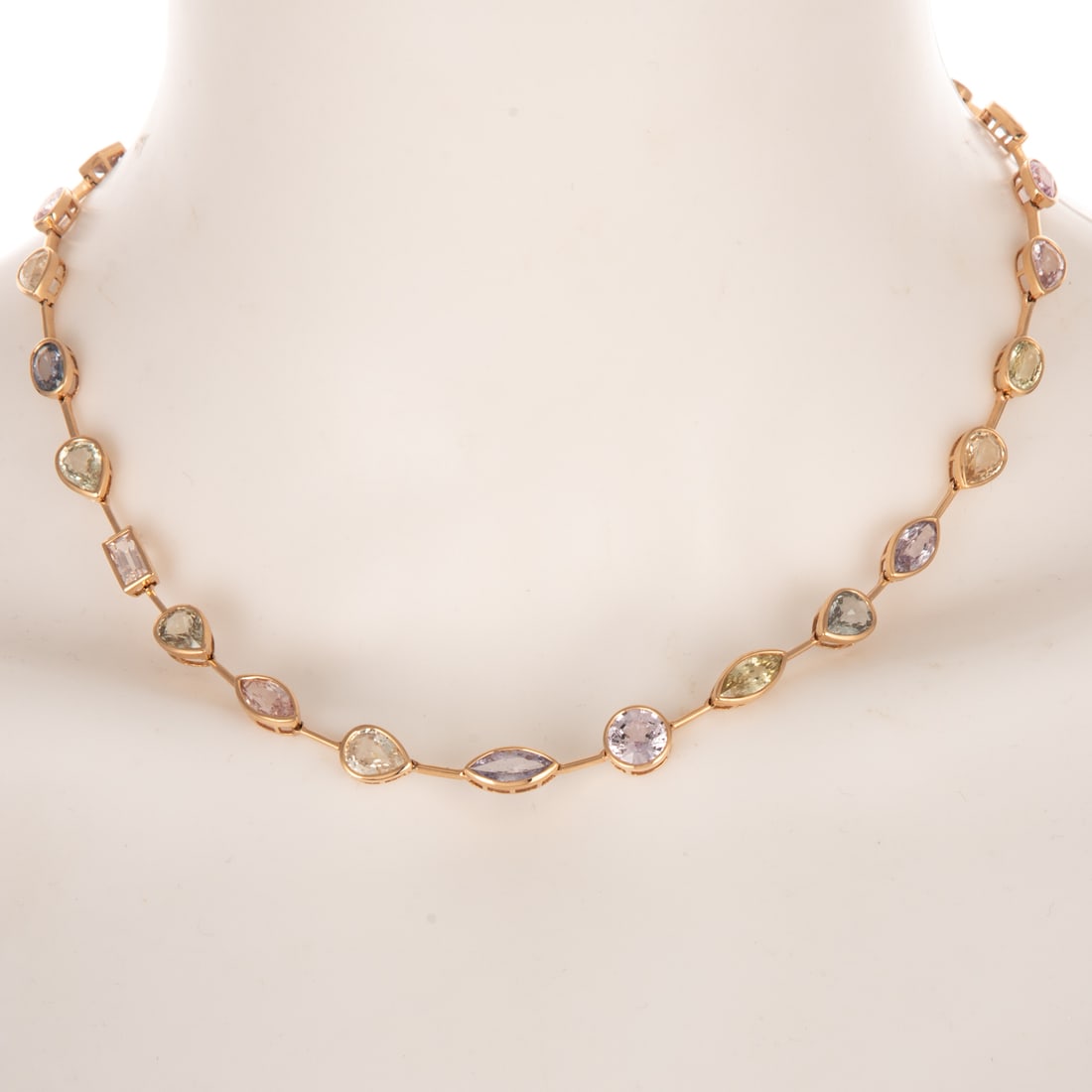 A GIA Unheated Multi-Colored Sapphire Necklace in 14K: 14K rose gold necklace featuring a line of unheated multi-colored mixed cut sapphires weighing approx. 31.50 ctw, accompanied by GIA Gemological Report #6234048915, each stone is bezel set and connect