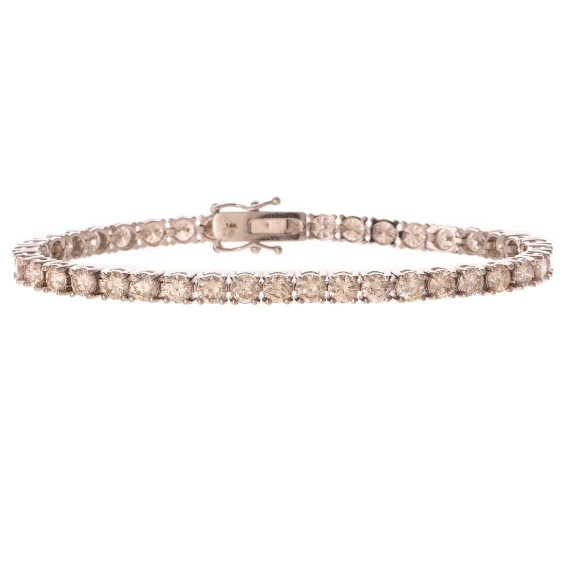 A 9.50 ctw Diamond Line Bracelet in 14K: 14K white gold bracelet featuring a line of individually prong set round diamonds weighing approx. 9.50 ctw with an average color grade of J - K and an average clarity grade of SI, hidden box clasp wi