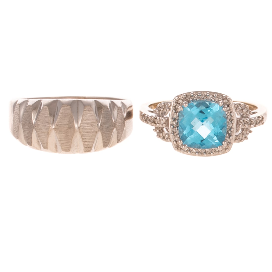 Two White Gold Rings in 10K: 1) 10K white gold ring featuring a prong set checkerboard cushion cut blue topaz surrounded a bead set diamond halo, additional bead set diamonds set on shank, signed, sz 8.75, and 2) 10K white gold