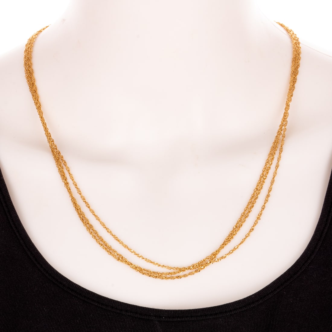 A Triple Chain Necklace in 18K: 18K yellow gold necklace by Milor, made in Italy, designed thee twisted rope chains connected at the back with lobster clasp, signed, 22 in. L, 6.4 grams Provenance: From the Estate of Nancy Muir,