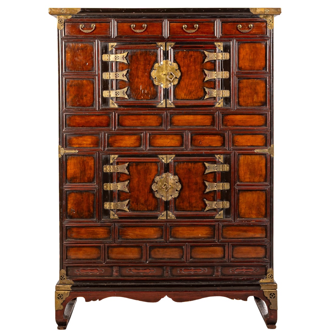 Korean Paulownia Wood Chest: Mid-19th century, shaped top over four door cabinet surrounded by carved panels, brass mounting throughout, Chow form legs connected by side stretchers, 53 1/4 in. H, 38 1/4 in. W, 17 in. D