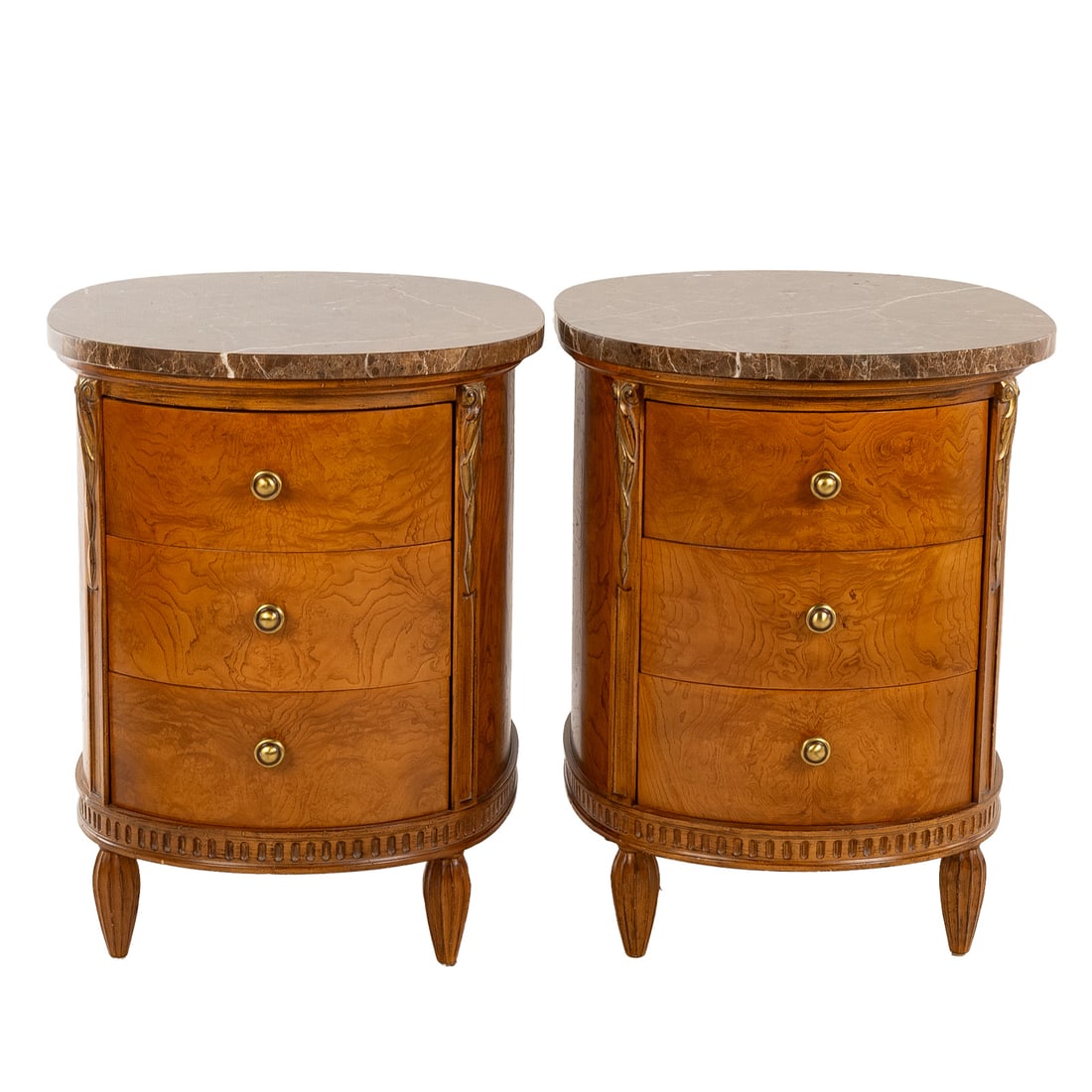 A Pair of Jeffco Marble Top Bedside Chests: Oval marble variegated marble tops over burl walnut three-drawer cases ending in stylized reeded legs, each: 31 1/2 in. H, 24 3/4 in. W, 32 in. D