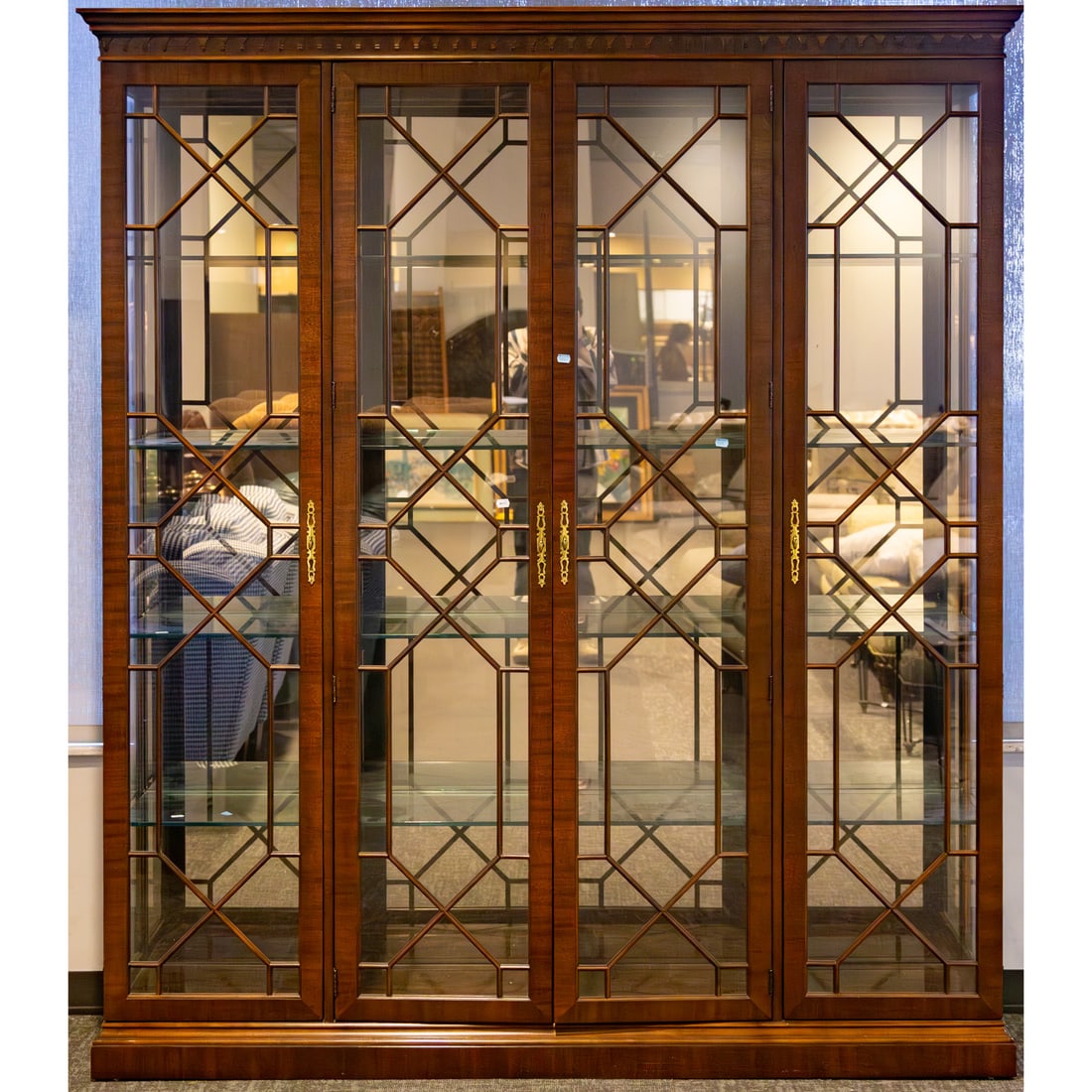 Large Henredon Chippendale Style Display Cabinet: Electrified cabinet with projecting cornice with carved running frieze over four glazed and muntined doors on a flush to floor base, 84 in. H, 74 in. W, 17 in. D
