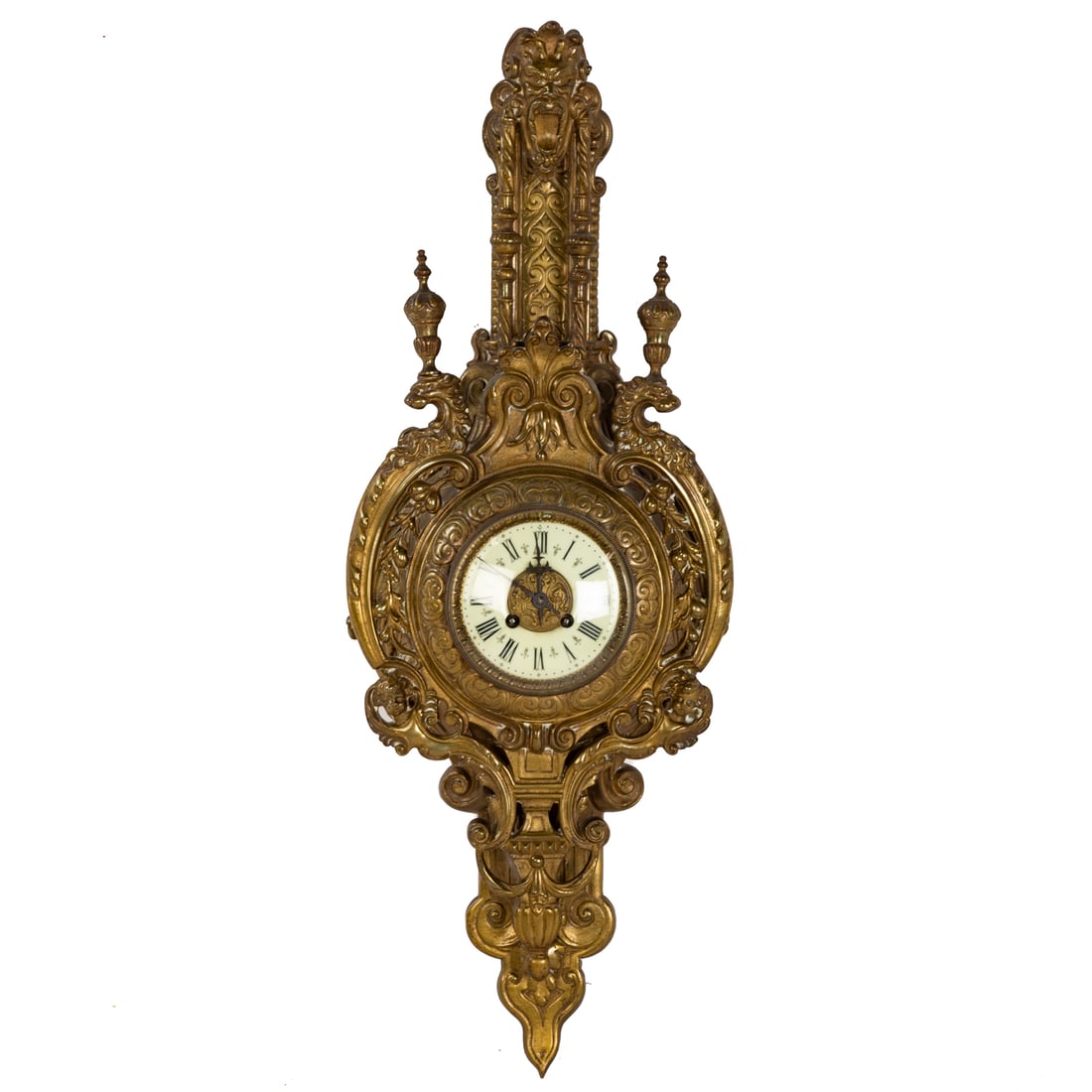A Louis XVI Style Bronze Dore Cartel Clock: Last quarter 19th century, works unsigned, the bronze dore case featuring scrolls, putti, and lions, surmounted by a masque, enamel face with Roman numerals, 30 in. H, 11 in. W, 4 1/2 in. D