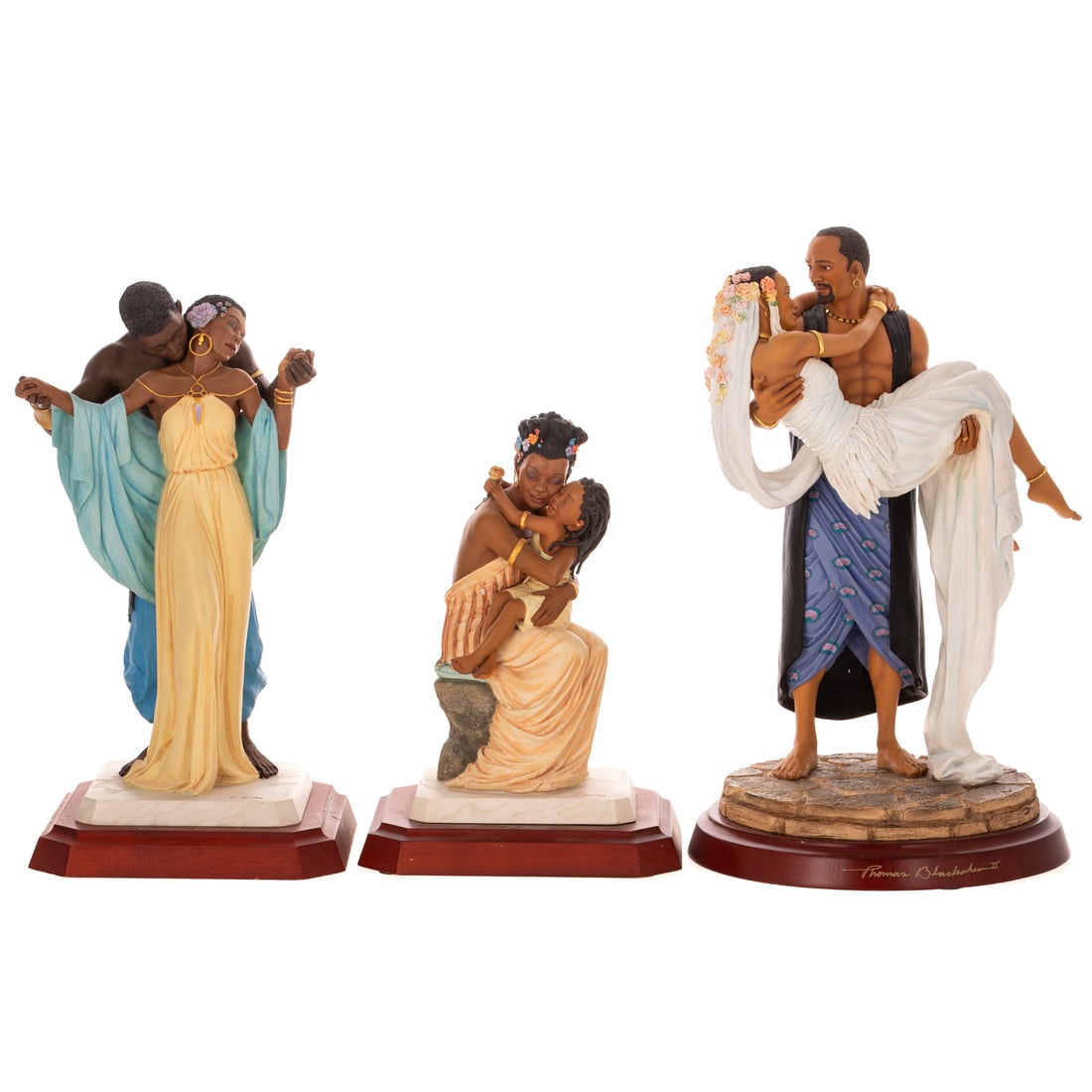 Three Thomas Blackshear's Ebony Visions Figures: Including a hand cast resin Thomas Blackshear's "The Nurturer" depicting a woman holding embracing her young daughter, limited edition, stamped, marked on bottom, includes original box, 9 in. H, 6 1/2