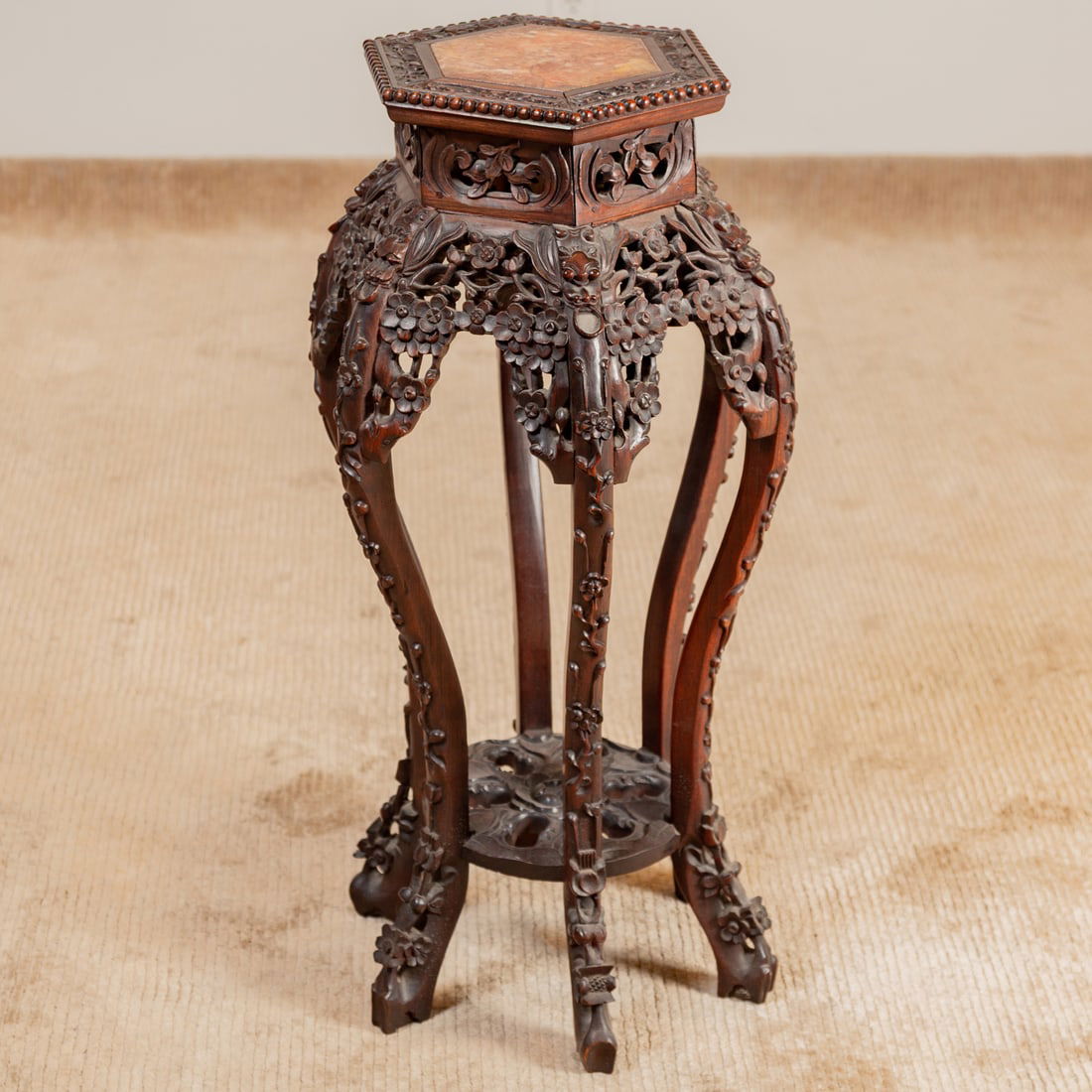 Chinese Carved Hardwood Marble Top Tabouret: Hexagonal top with rose marble inset over elaborately carved apron and legs, connected at the base with a circular and reticulated undershelf, 32 1/2 in. H, 16 in. Diam.