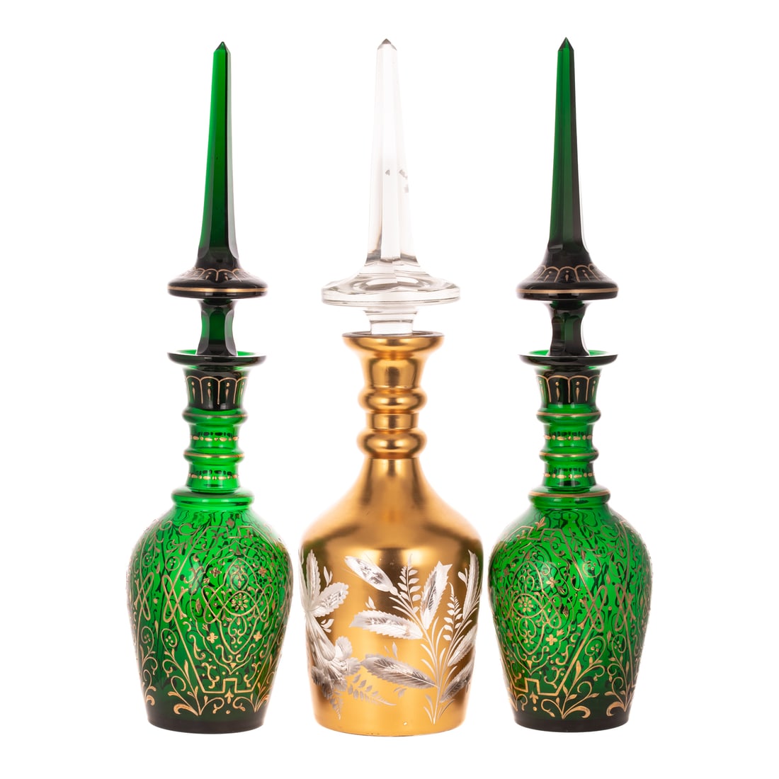 Two European Emerald & One Gilt Glass Decanters: 20th century, former with gilt enamel arabesque decoration, each with noded neck, flared lip and faceted spire-form lids; the latter with intaglio engraved floral decoration, size of tallest: 26 in. H
