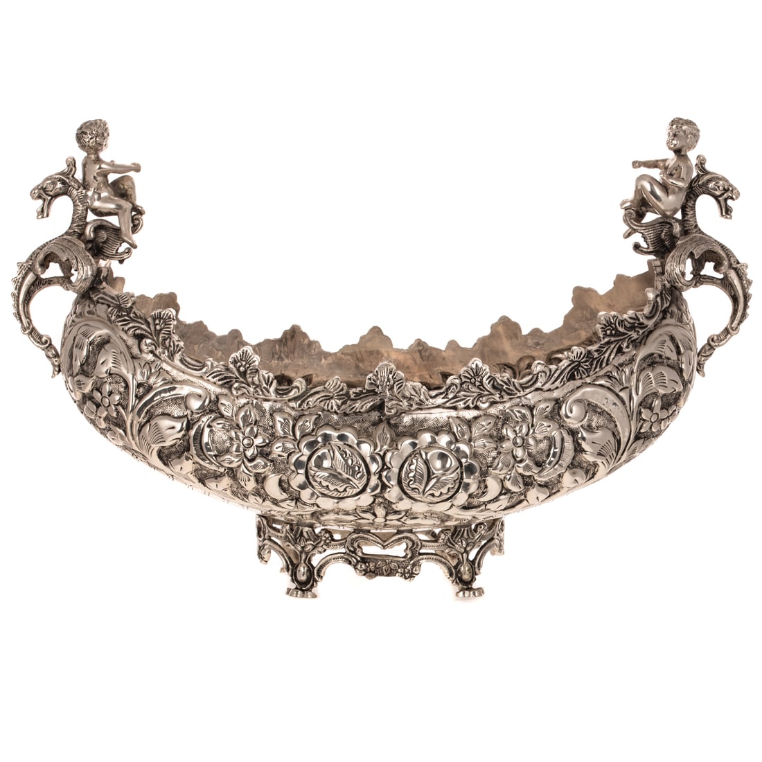 Large Silver Plated Centerbowl: 20th century, boat-form, hammered interior bottom, the sides modeled with flowers and foliage, the griffin handles mounted with putti, raised on an open-work foot, 12 in. H, 19 1/4 in. W overall, 8