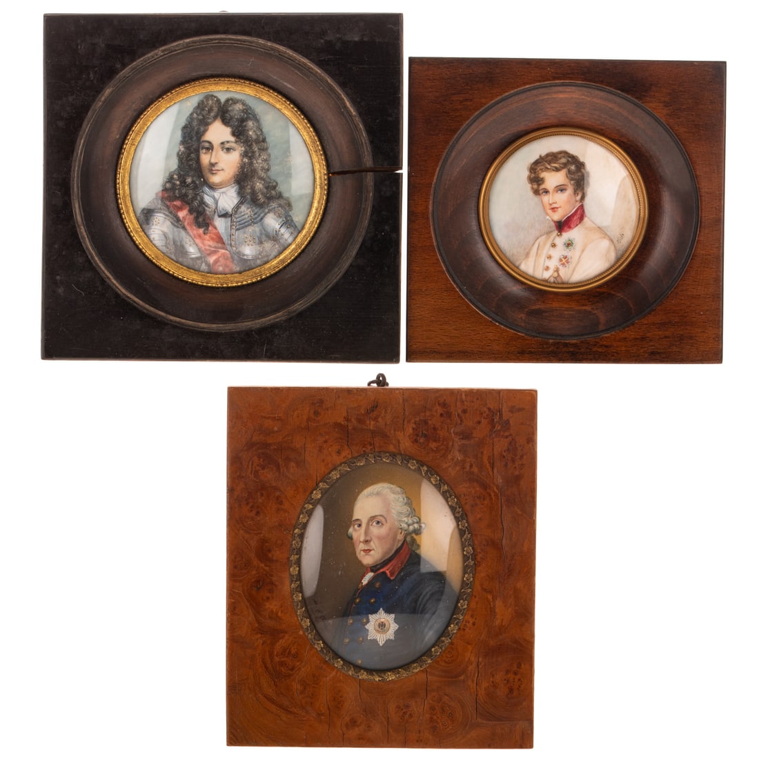 Three Continental Painted Miniature Portraits: Late 19th century, Frederick the Great after Anton Graff, oval in burlwood frame, 3 1/4 x 2 1/2 in.; Late 19th century, Louis IVX in Parade Armor, in ebonized frame, 2 7/8 in. Diam.; and early 20th