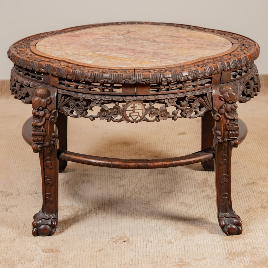 Chinese Carved Hardwood Marble Top Table: Lobed carved edge with marble insert, carved and reticulated apron resting on carved straight legs connected by a circular stretcher, 26 in. H, 40 in. Sq.