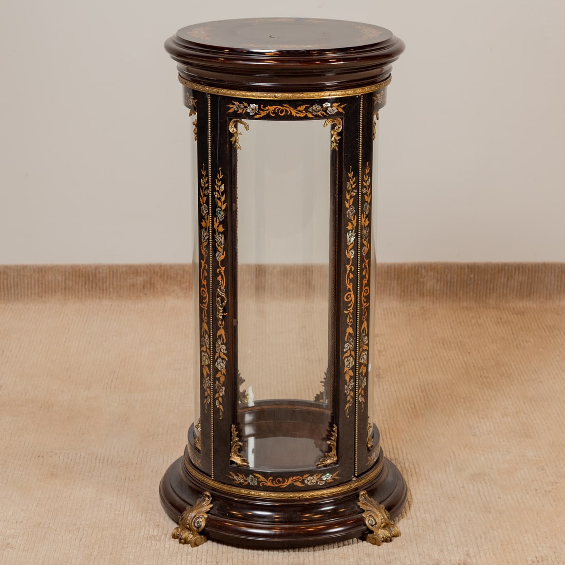 French Empire Style Cylindrical Display Cabinet: Black lacquer finish with enamel and mother of pearl inlay with applied ormolu mounts on a circular base resting on gilt metal feet, 40 in. H, 21 in. Diam.