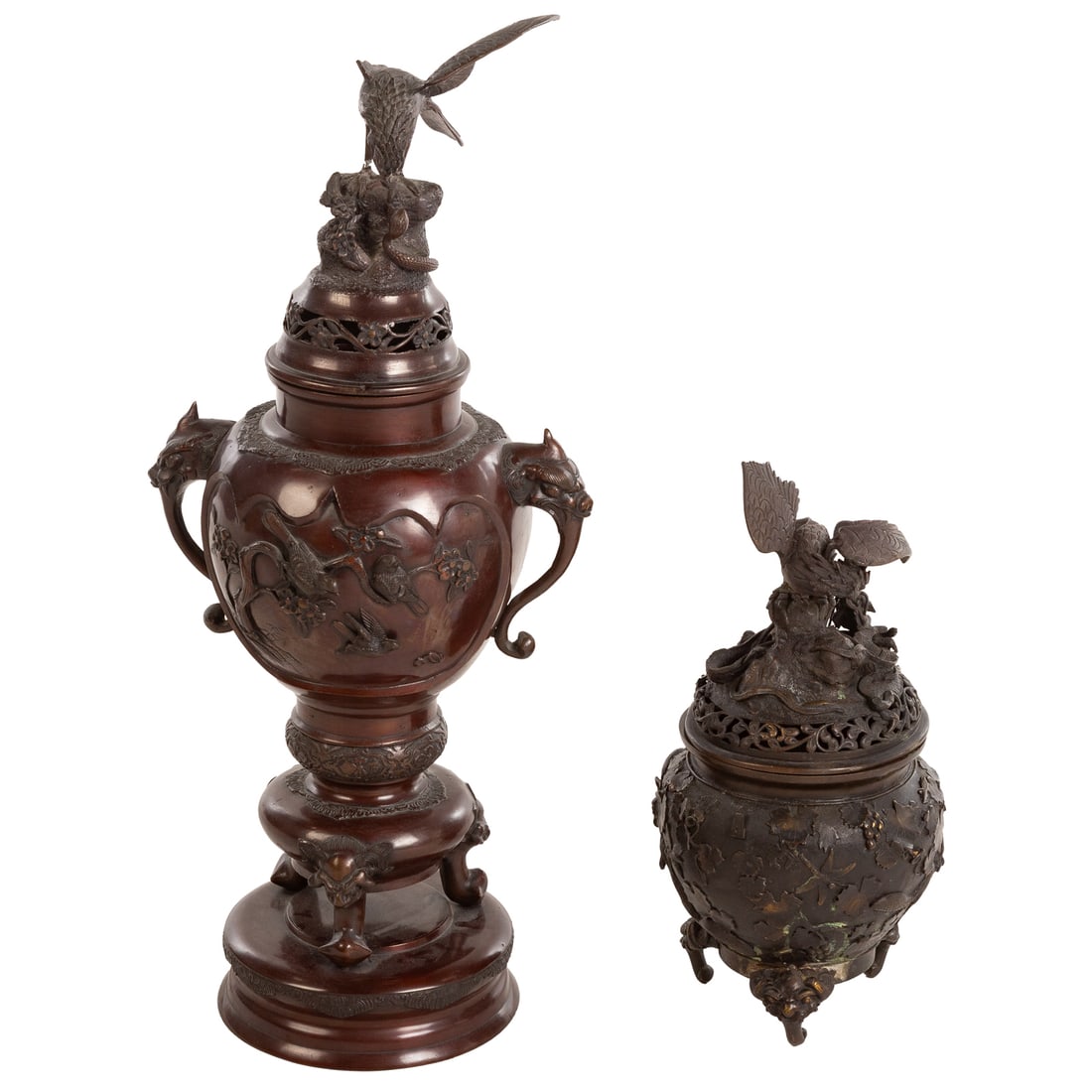 Two Japanese Bronze Figural Censers: 1) Lidded censer with eagle battling a cobra over bird and branch relief motifs, 28 1/2 in. H, 12 in. W, and 2) Smaller lidded censer with eagle and dragon atop a foliage, 16 1/2 in. H, 7 in. Diam.