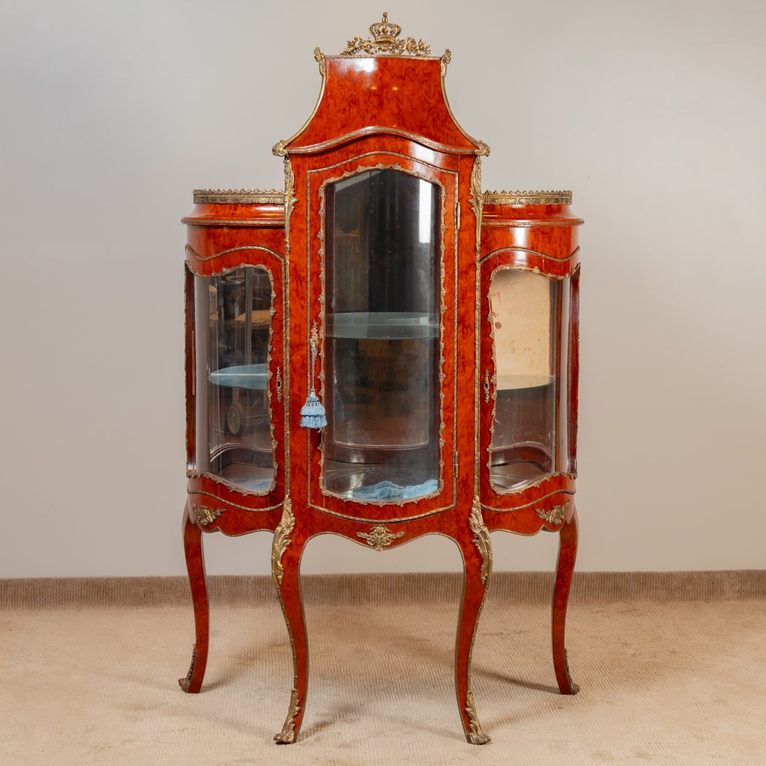 Louis XV Style Ormolu Mounted Walnut Cabinet: Three section swelling display cabinet with curved glass doors and applied ormolu mounting throughout, supported on cabriole legs, 79 in. H, 46 in. W, 22 in. D