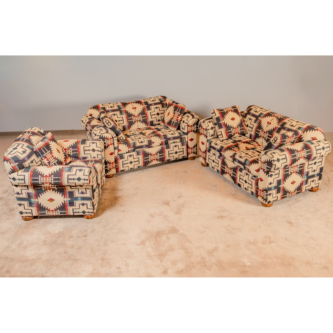 Contemporary Three Piece Parlor Set: Comprising a pair of fully Navajo inspired upholstered loveseats, 33 in. H, 63 in. W, 37 in. D, and a matching armchair, 36 in. H, 38 in. W, 36 in. D